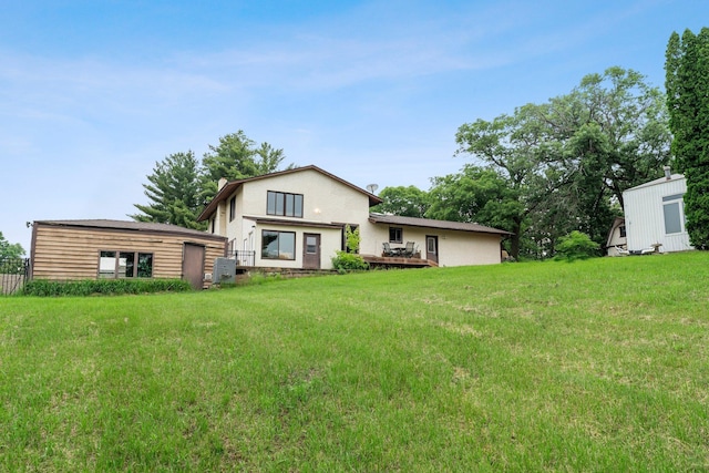 7567 Lent Trl, Lent Twp, MN 55079 - rear view of property with a deck, a yard, an outdoor structure, and stucco siding
