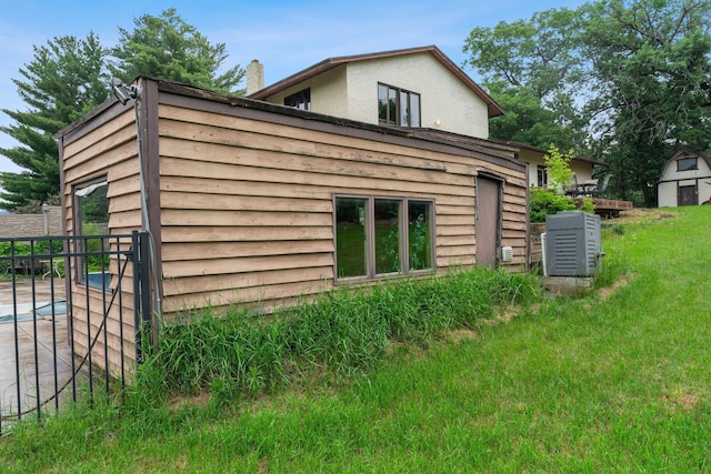 7567 Lent Trl, Lent Twp, MN 55079 - view of side of property featuring a chimney, stucco siding, and a yard