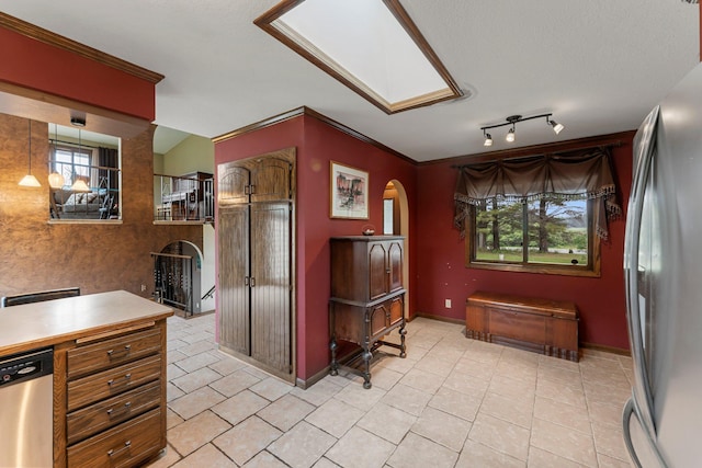 7567 Lent Trl, Lent Twp, MN 55079 - kitchen with arched walkways, appliances with stainless steel finishes, light tile patterned floors, and light countertops
