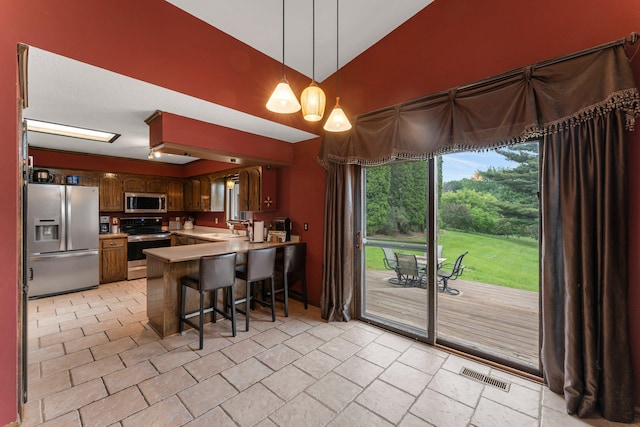 7567 Lent Trl, Lent Twp, MN 55079 - kitchen featuring stainless steel appliances, high vaulted ceiling, a peninsula, light countertops, and decorative light fixtures