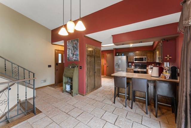 7567 Lent Trl, Lent Twp, MN 55079 - kitchen featuring stainless steel appliances, a kitchen breakfast bar, a peninsula, and decorative light fixtures