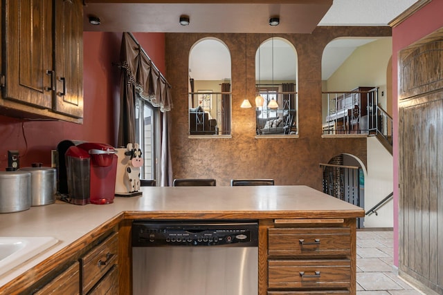 7567 Lent Trl, Lent Twp, MN 55079 - kitchen featuring dishwasher, light countertops, a peninsula, light tile patterned floors, and brown cabinetry
