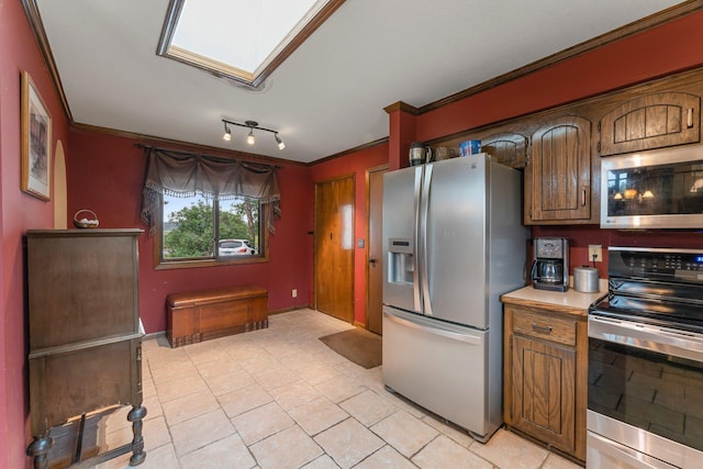 7567 Lent Trl, Lent Twp, MN 55079 - kitchen featuring stainless steel appliances, ornamental molding, light countertops, light tile patterned flooring, and a skylight
