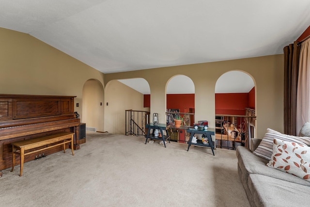 7567 Lent Trl, Lent Twp, MN 55079 - sitting room featuring arched walkways, carpet floors, an upstairs landing, and vaulted ceiling