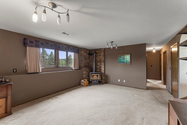 7567 Lent Trl, Lent Twp, MN 55079 - unfurnished living room with a wood stove, a textured ceiling, and carpet