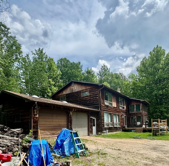 1831 State Highway 11 SE, Gudrid Twp, MN 56623 - rear view of property featuring dirt driveway and an attached garage