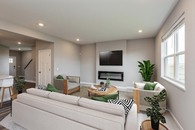 1549 143rd St E, Rosemount, MN 55068 - living area with baseboards, recessed lighting, healthy amount of natural light, a glass covered fireplace, and stairs