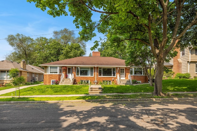 4922 Sheridan Ave S, Minneapolis, MN 55410 - view of front facade with brick siding, a chimney, entry steps, and a front yard