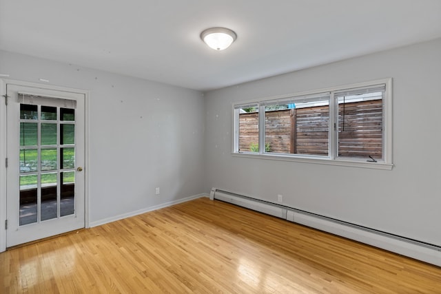 4922 Sheridan Ave S, Minneapolis, MN 55410 - spare room featuring a baseboard heating unit, light wood-style floors, and baseboards