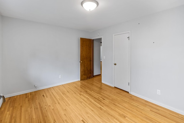 4922 Sheridan Ave S, Minneapolis, MN 55410 - unfurnished room with baseboards, light wood finished floors, and baseboard heating