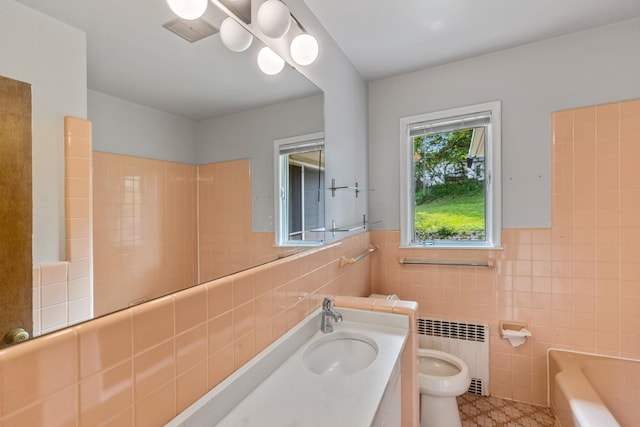 4922 Sheridan Ave S, Minneapolis, MN 55410 - bathroom with tile walls, radiator, a bathtub, vanity, and toilet