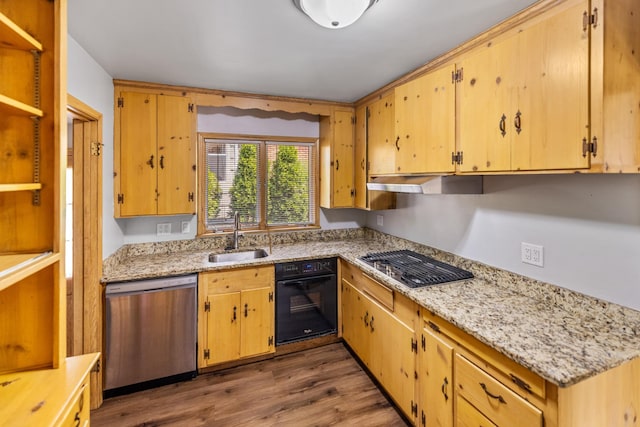 4922 Sheridan Ave S, Minneapolis, MN 55410 - kitchen featuring stainless steel appliances, a sink, under cabinet range hood, dark wood finished floors, and light stone countertops