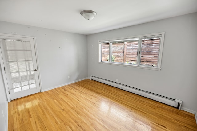 4922 Sheridan Ave S, Minneapolis, MN 55410 - unfurnished room with a baseboard radiator, light wood-style flooring, and baseboards