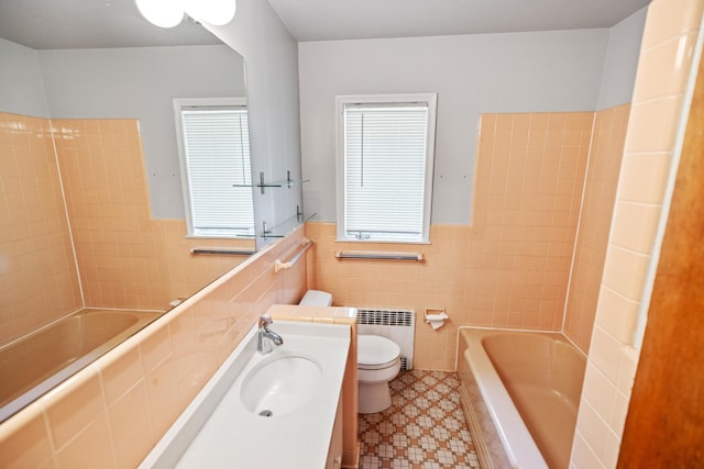 4922 Sheridan Ave S, Minneapolis, MN 55410 - full bathroom with radiator heating unit, tile walls, toilet, vanity, and a wainscoted wall