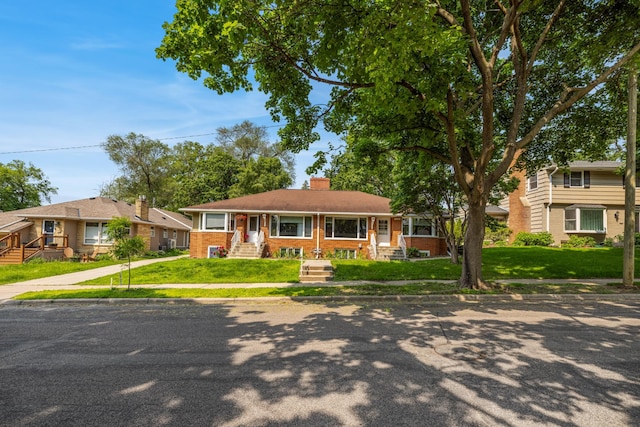 4922 Sheridan Ave S, Minneapolis, MN 55410 - view of front of property with a chimney, a front yard, brick siding, and covered porch