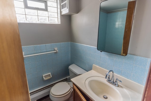 4922 Sheridan Ave S, Minneapolis, MN 55410 - half bathroom featuring toilet, tile walls, vanity, a baseboard radiator, and a wainscoted wall