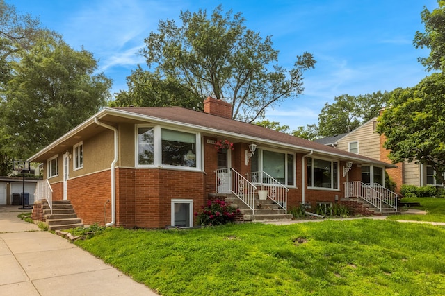 4922 Sheridan Ave S, Minneapolis, MN 55410 - view of front facade with a chimney, a front lawn, and brick siding
