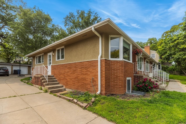 4922 Sheridan Ave S, Minneapolis, MN 55410 - view of front of property with brick siding, stucco siding, a garage, an outdoor structure, and a chimney