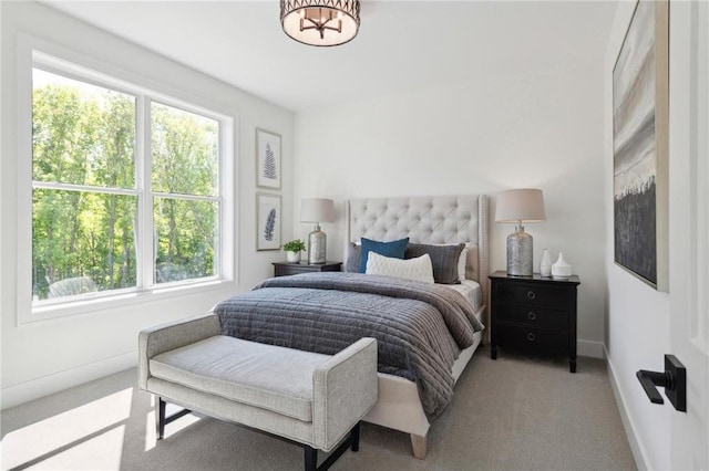 carpeted bedroom with multiple windows and baseboards