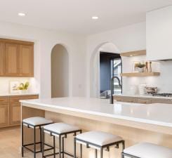 kitchen featuring a kitchen breakfast bar, light countertops, arched walkways, and recessed lighting