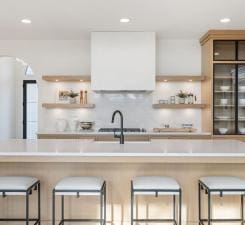 kitchen featuring open shelves, decorative backsplash, light countertops, recessed lighting, and a breakfast bar