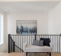 sitting room with healthy amount of natural light and an upstairs landing