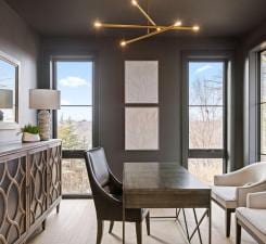 sunroom / solarium featuring a chandelier