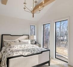 bedroom with access to exterior, a chandelier, and high vaulted ceiling
