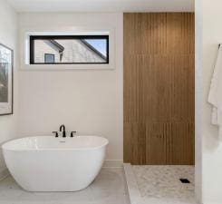 full bath with a freestanding bath, plenty of natural light, and tile patterned floors