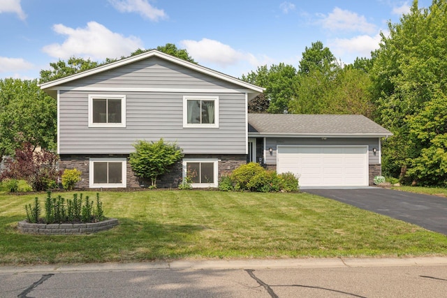20561 Jade Cir, Lakeville, MN 55044 - split level home with asphalt driveway, a garage, a front yard, and stone siding
