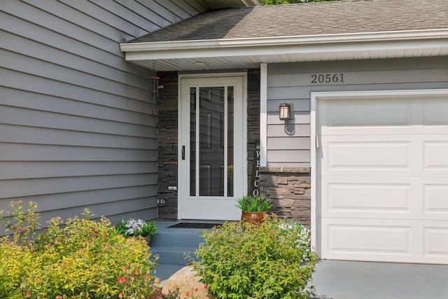 20561 Jade Cir, Lakeville, MN 55044 - doorway to property with stone siding and a shingled roof