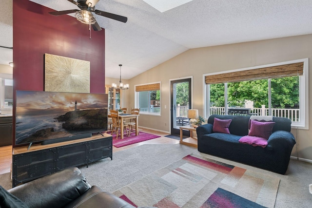 20561 Jade Cir, Lakeville, MN 55044 - carpeted living area featuring a chandelier, a ceiling fan, lofted ceiling, baseboards, and a textured ceiling