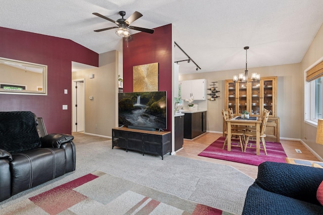 20561 Jade Cir, Lakeville, MN 55044 - living area with a chandelier, a ceiling fan, vaulted ceiling, rail lighting, and baseboards