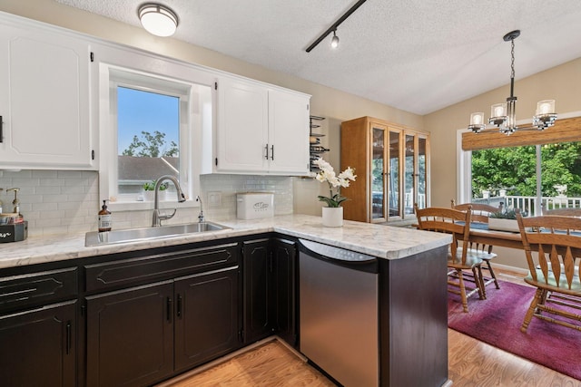 20561 Jade Cir, Lakeville, MN 55044 - kitchen with a sink, dishwasher, white cabinets, a textured ceiling, and backsplash