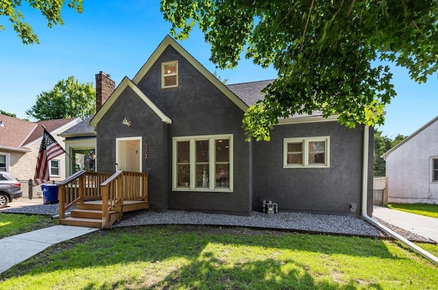 1372 Victoria St N, Saint Paul, MN 55117 - view of front of home featuring a chimney, a front yard, and stucco siding