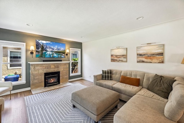 1372 Victoria St N, Saint Paul, MN 55117 - living area featuring wood finished floors, a wood stove, baseboards, and recessed lighting