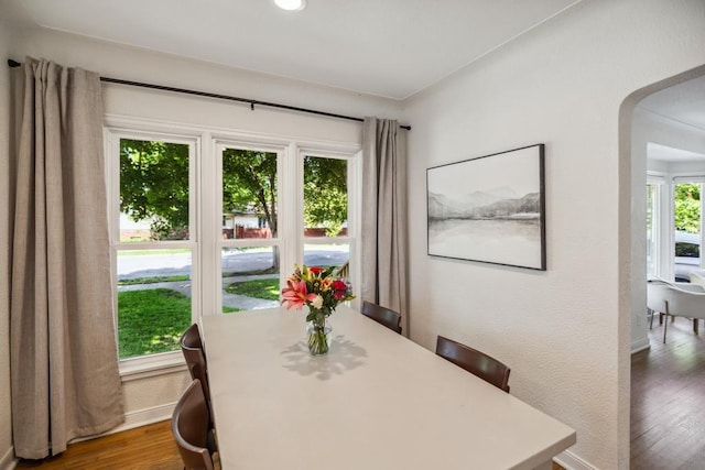 1372 Victoria St N, Saint Paul, MN 55117 - dining space with arched walkways, wood finished floors, and baseboards
