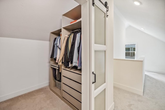 1372 Victoria St N, Saint Paul, MN 55117 - walk in closet with light carpet, vaulted ceiling, and a barn door