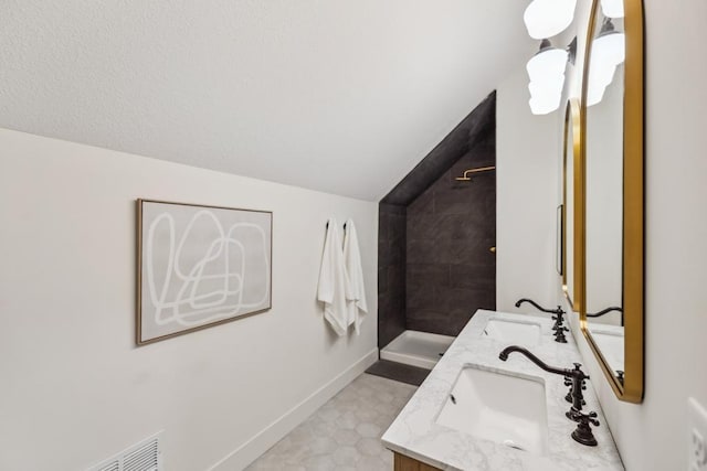 1372 Victoria St N, Saint Paul, MN 55117 - full bath with vaulted ceiling, double vanity, tiled shower, and baseboards