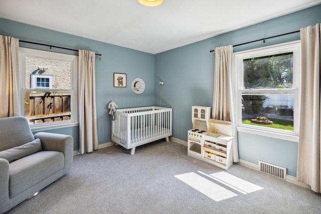 1372 Victoria St N, Saint Paul, MN 55117 - carpeted bedroom featuring a crib and baseboards