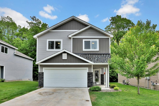 30619 Revere Ave, Shafer, MN 55074 - view of front of home featuring a garage, a front yard, concrete driveway, and stone siding