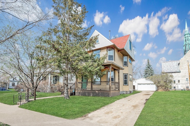 1527 Minnehaha Ave W, Saint Paul, MN 55104 - victorian house with an outdoor structure, covered porch, a detached garage, and a front lawn
