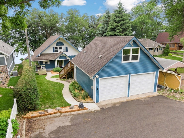 3886 Eagle Rd, Willmar, MN 56201 - view of front of property with a porch, a shingled roof, a front yard, and asphalt driveway