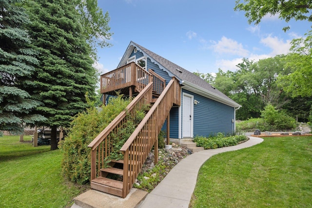 3886 Eagle Rd, Willmar, MN 56201 - view of side of property featuring a lawn, a wooden deck, stairway, and roof with shingles