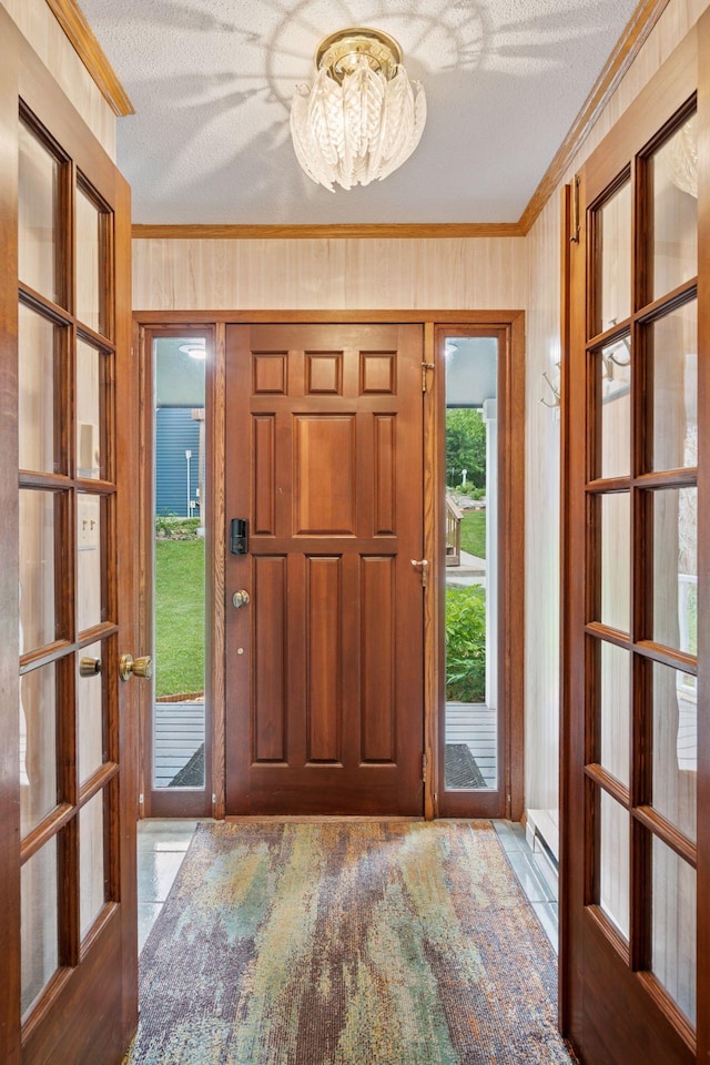 3886 Eagle Rd, Willmar, MN 56201 - foyer with ornamental molding, a chandelier, a textured ceiling, and french doors