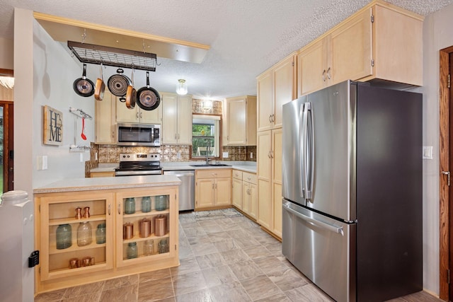 3886 Eagle Rd, Willmar, MN 56201 - kitchen featuring stainless steel appliances, light brown cabinetry, light countertops, a textured ceiling, and tasteful backsplash
