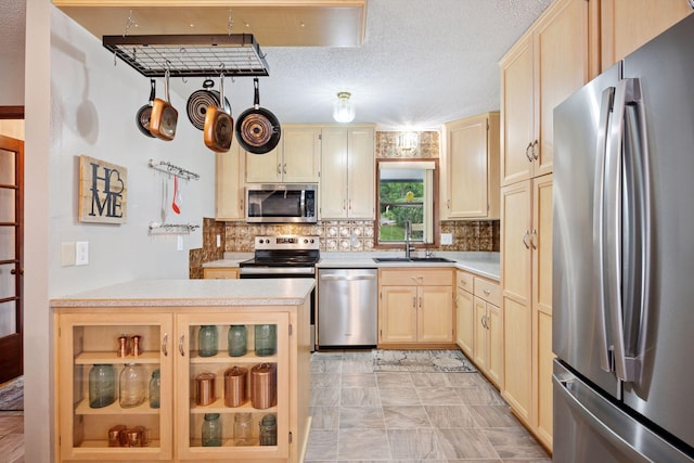 3886 Eagle Rd, Willmar, MN 56201 - kitchen featuring appliances with stainless steel finishes, light countertops, tasteful backsplash, light brown cabinets, and glass insert cabinets