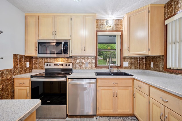 3886 Eagle Rd, Willmar, MN 56201 - kitchen featuring stainless steel appliances, light brown cabinets, light countertops, a textured ceiling, and backsplash