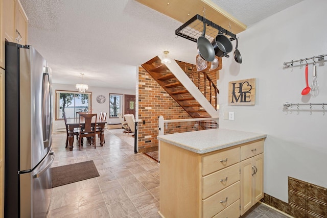 3886 Eagle Rd, Willmar, MN 56201 - kitchen featuring freestanding refrigerator, a textured ceiling, a chandelier, light countertops, and light brown cabinetry