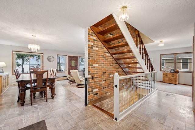 3886 Eagle Rd, Willmar, MN 56201 - staircase featuring a chandelier, a textured ceiling, and a baseboard radiator